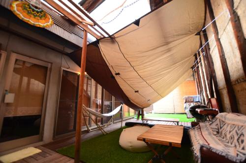 a room with a hammock and a table and chairs at Colours in Kyoto