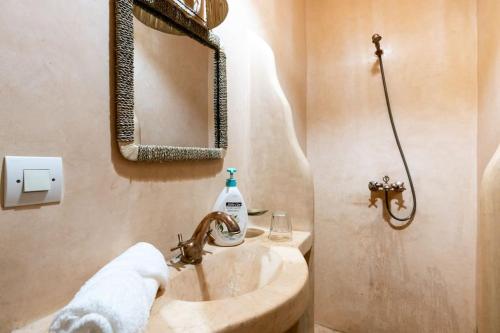 a bathroom with a sink and a mirror at Central Entire and exclusive house ,Ryad no shared in Marrakesh