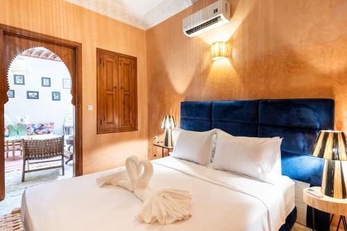 a bedroom with a bed with a towel on it at Central Entire and exclusive house ,Ryad no shared in Marrakesh