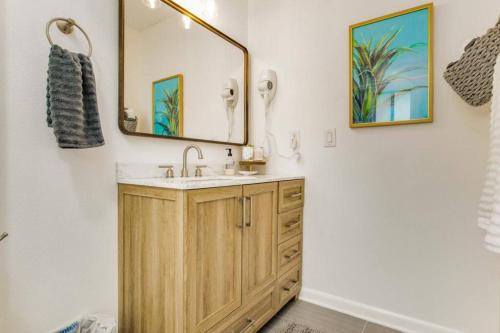 a bathroom with a sink and a mirror at Woodsy Retreat, steps to Bay - Hot tub! in Gulf Breeze