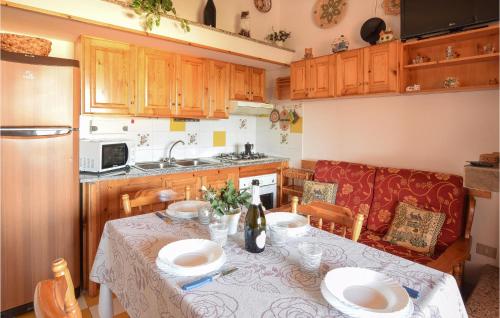 a kitchen with a table with plates on it at Lovely Apartment In Torre Dei Corsari in Torre Dei Corsari