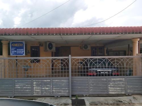 a building with a fence in front of it at Raja Homestay Kluang in Kluang