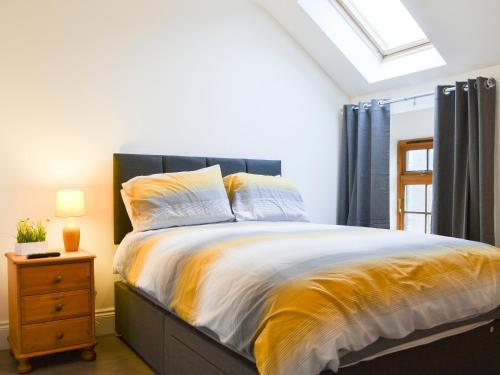 a bedroom with a large bed and a window at Sunset View-e4107a in Aspatria