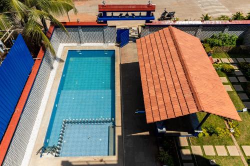 an overhead view of a swimming pool with a roof at Panism Lifestyle in Auroville