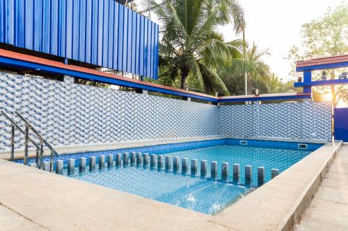 a swimming pool with blue tiles on a building at Panism Lifestyle in Auroville