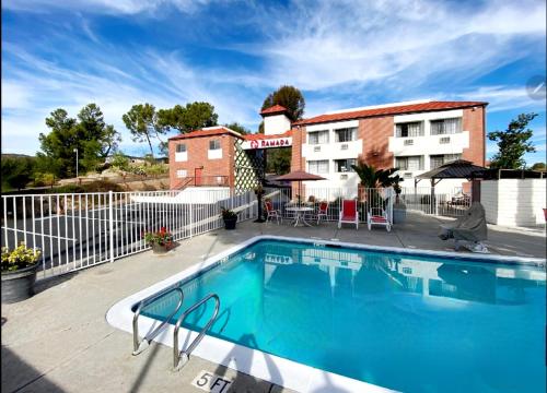 a swimming pool in front of a hotel at Ramada by Wyndham San Diego Poway Miramar in Poway