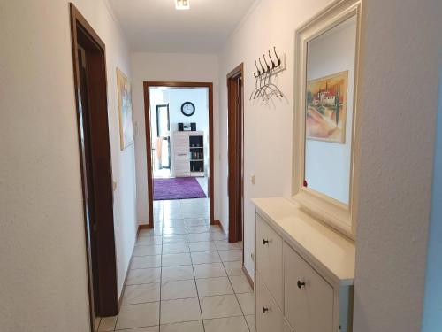 a hallway of a home with a white tile floor at Ferienwohnung Seeblick in Schalkenmehren