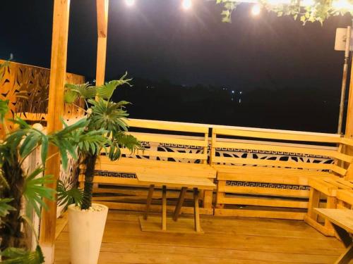 a porch with a bench and a table on a balcony at Amazing Waterfront 1-Bed Apt With 24HRS PWR And Starlink SuperFast Speed WiFi in Lagos