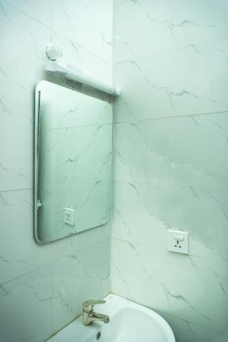 a bathroom with a mirror and a sink at Amazing Waterfront 1-Bed Apt With 24HRS PWR And Starlink SuperFast Speed WiFi in Lagos