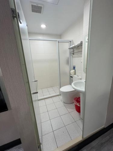 a bathroom with a shower and a toilet at Sun Star Business Hotel in Taipei