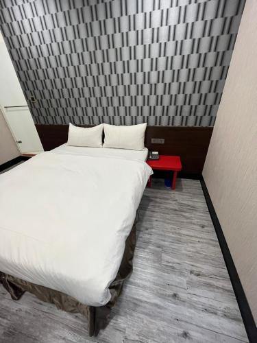 a bedroom with a large white bed in a room at Sun Star Business Hotel in Taipei