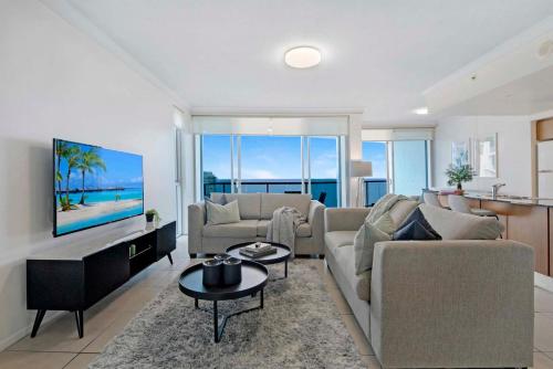 a living room with a couch and a table at Chevron Renaissance - Self Contained Apartments - Wow Stay in Gold Coast