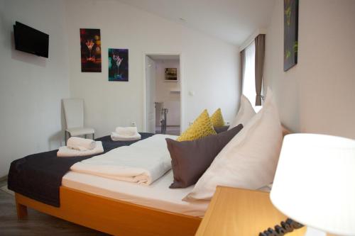 a bedroom with a bed with pillows on it at Villa Toni Design Apartments in Split