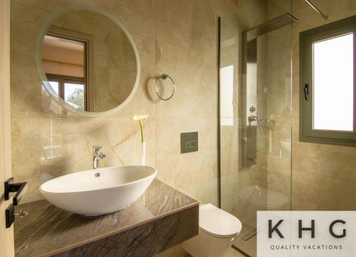 a bathroom with a sink and a toilet and a mirror at Tania's Villa in Dorizata village! in Dhorizáta