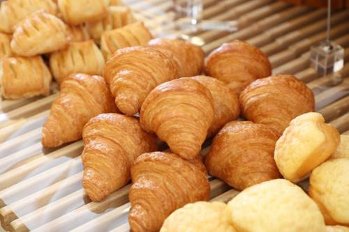 a bunch of croissants and other pastries on a display at Hiroshima Tokyu REI Hotel in Hiroshima