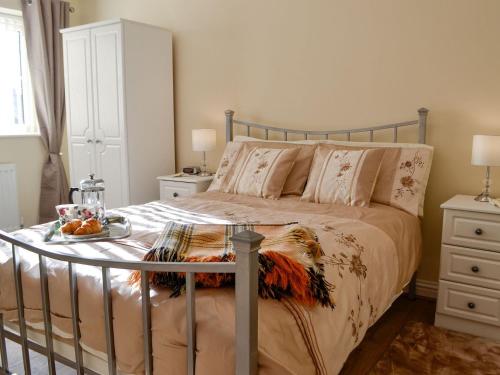 a bedroom with a bed with a tray of fruit on it at Penmaen in Talgarth