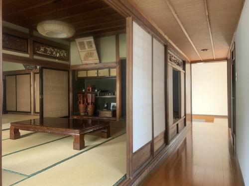a room with a wooden table in a building at Minka -STAY Traditional Japanese houses in Miyoshi