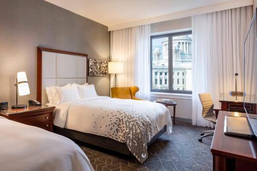 a hotel room with a bed and a desk and a window at Renaissance Providence Downtown Hotel in Providence