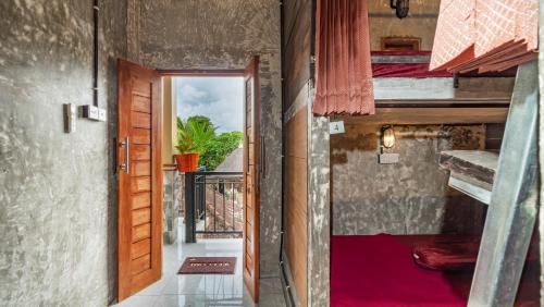 an open door to a room with bunk beds at Peanut House in Ubud