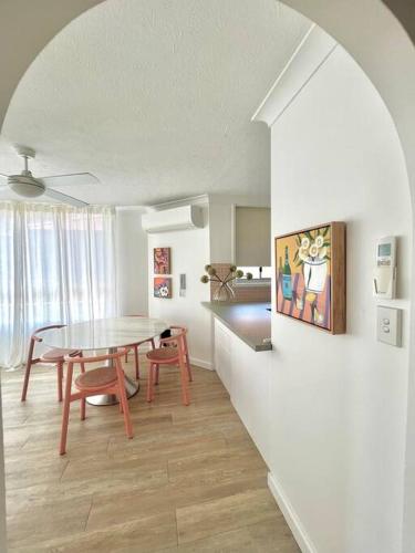 a living room with a table and a dining room at Blush on Broadbeach- beachside and pet friendly, 3rd floor walk up in Gold Coast