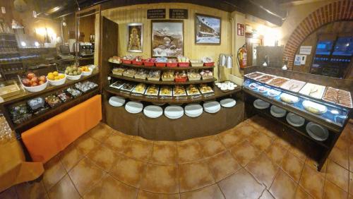 a bakery with a lot of food on display at Hotel Sarao in Escarrilla