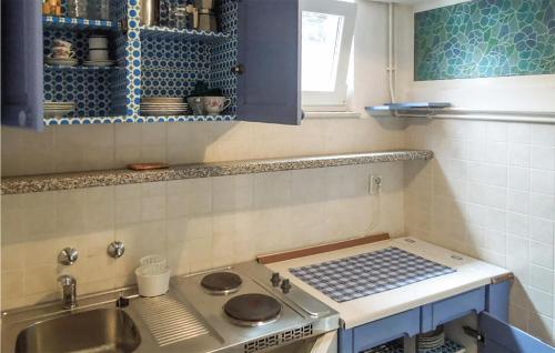 a kitchen with a sink and a stove top oven at Beautiful Apartment In Martinscica With Kitchen in Martinšćica