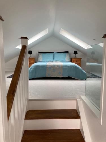 a bedroom with a bed with blue pillows at Lakeview Country House & Apartments in Killarney