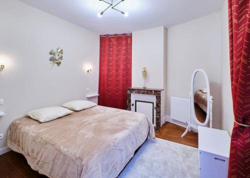 1 dormitorio con 1 cama grande y chimenea en La Porte Enchantée, en Chartres