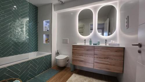 a bathroom with a sink and a toilet and a mirror at Mediterranean apartment Rosas in Roses