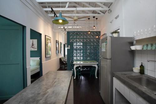 a kitchen with a counter top and a refrigerator at Stay SongSong Mount Erskine in George Town