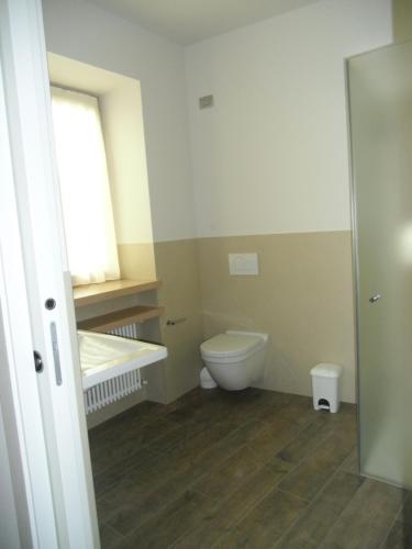 a bathroom with a toilet and a window at Agriturismo Casa Preti in Revò