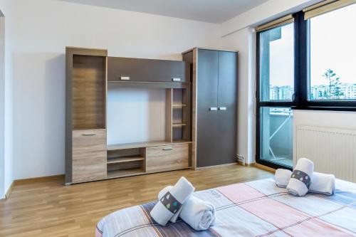 a bedroom with a bed and a large window at Central apartments - Red in Bacău