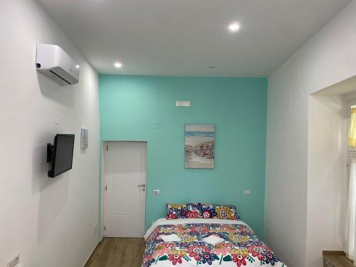 una camera con letto e parete blu di CANELLI HOUSE SORRENTO a Sorrento