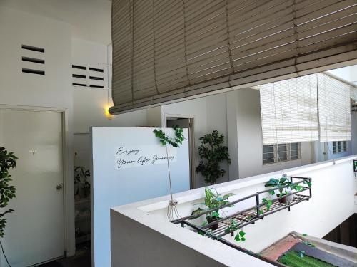 a kitchen with a counter with plants and a refrigerator at Digital Nomad House KL Bukit Bintang - Self service shared bathroom apartment in Kuala Lumpur