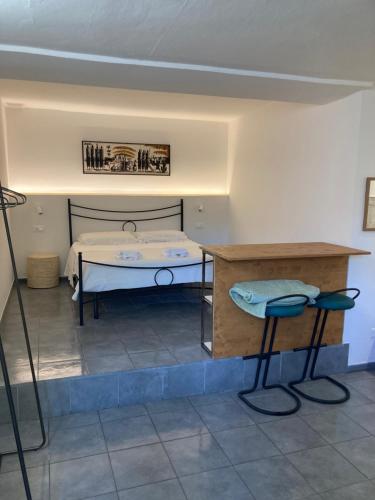 a room with a bed and a table and two stools at Rio Rest Apartments in Riomaggiore