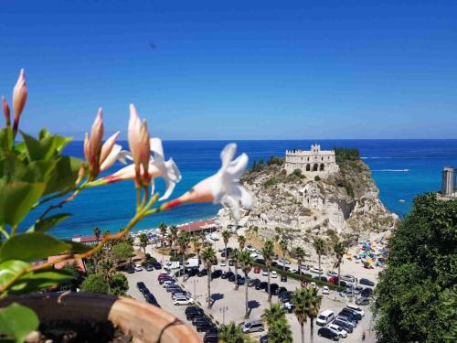 a view of a beach with a castle on a mountain at OLYMPUS ROOM in Tropea