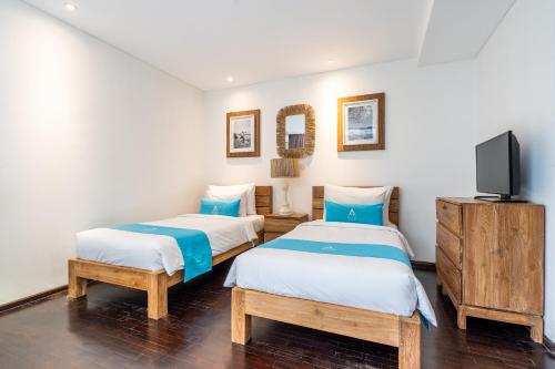 Ένα ή περισσότερα κρεβάτια σε δωμάτιο στο MANA Villas Nusa Dua