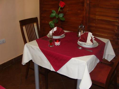 a red and white table with a red and white table cloth at Lugarnica in Zagreb