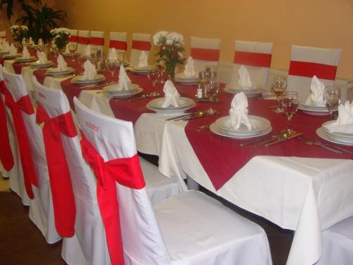 a set of tables with red and white table cloths at Lugarnica in Zagreb