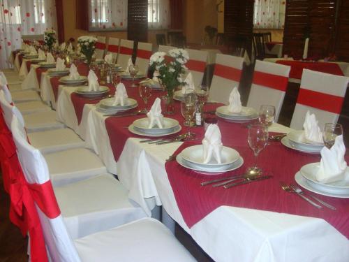 a long table with white and red tablecloths and napkins at Lugarnica in Zagreb
