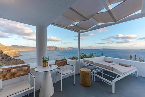 a patio with a view of the ocean at Helianthus Dream Homes in Oia
