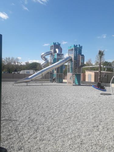 a slide at a playground in a park at mobil home neuf 2 chambres 6 personnes Saint Aygulf plage in Fréjus