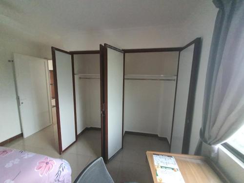 a room with two doors and a table and a window at MB Apartments & Hotel Medan in Sunggal