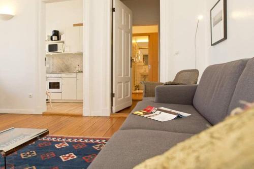 ein Wohnzimmer mit einem Sofa und einer Küche in der Unterkunft Villa Astrid, T4 Hamburg in Bansin