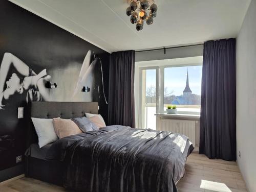 a bedroom with a large bed and a window at Lai Apartment in City center of Rakvere in Rakvere