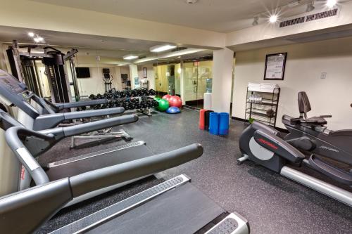 a gym with several treadmills and exercise machines at Hotel Le Marais in New Orleans