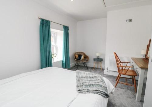 a bedroom with a bed and a desk and a chair at The Inn Keeper in Cranswick