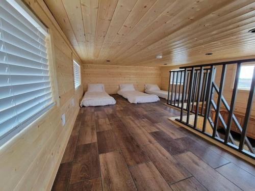 a room with two beds in a wooden house at 037 Tiny Home nr Grand Canyon South Rim Sleeps 8 in Valle