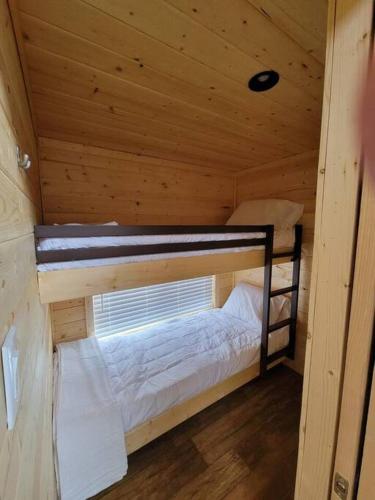 a small room with two bunk beds in a cabin at 037 Tiny Home nr Grand Canyon South Rim Sleeps 8 in Valle