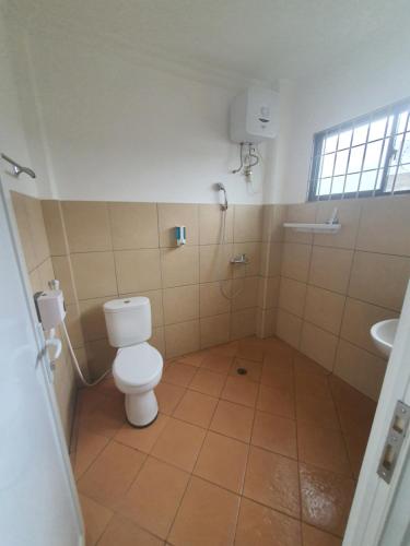 a bathroom with a toilet and a sink at MB Apartments & Hotel Medan in Sunggal